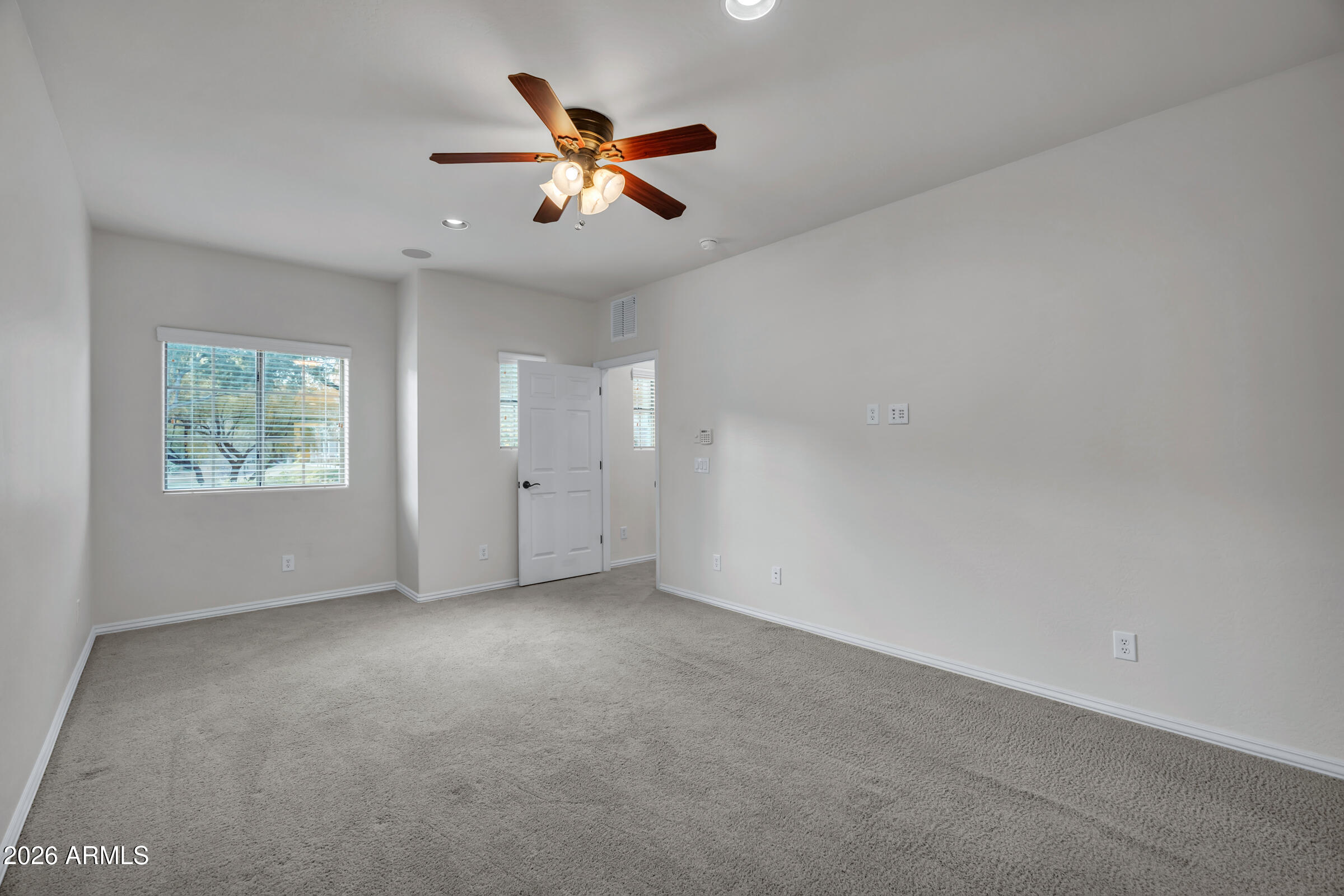 3935 East Rough Rider Road, Unit 1250 Phoenix, AZ 85050 - Photo 19 of 29 an empty room with windows and fan