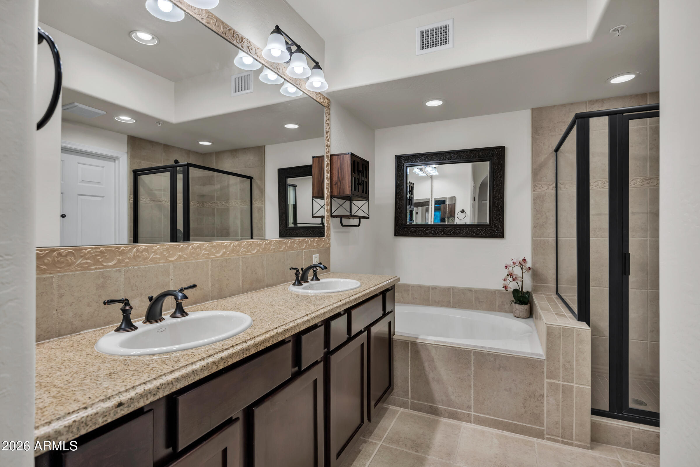 3935 East Rough Rider Road, Unit 1250 Phoenix, AZ 85050 - Photo 20 of 29 a bathroom with a granite countertop sink mirror and bathtub