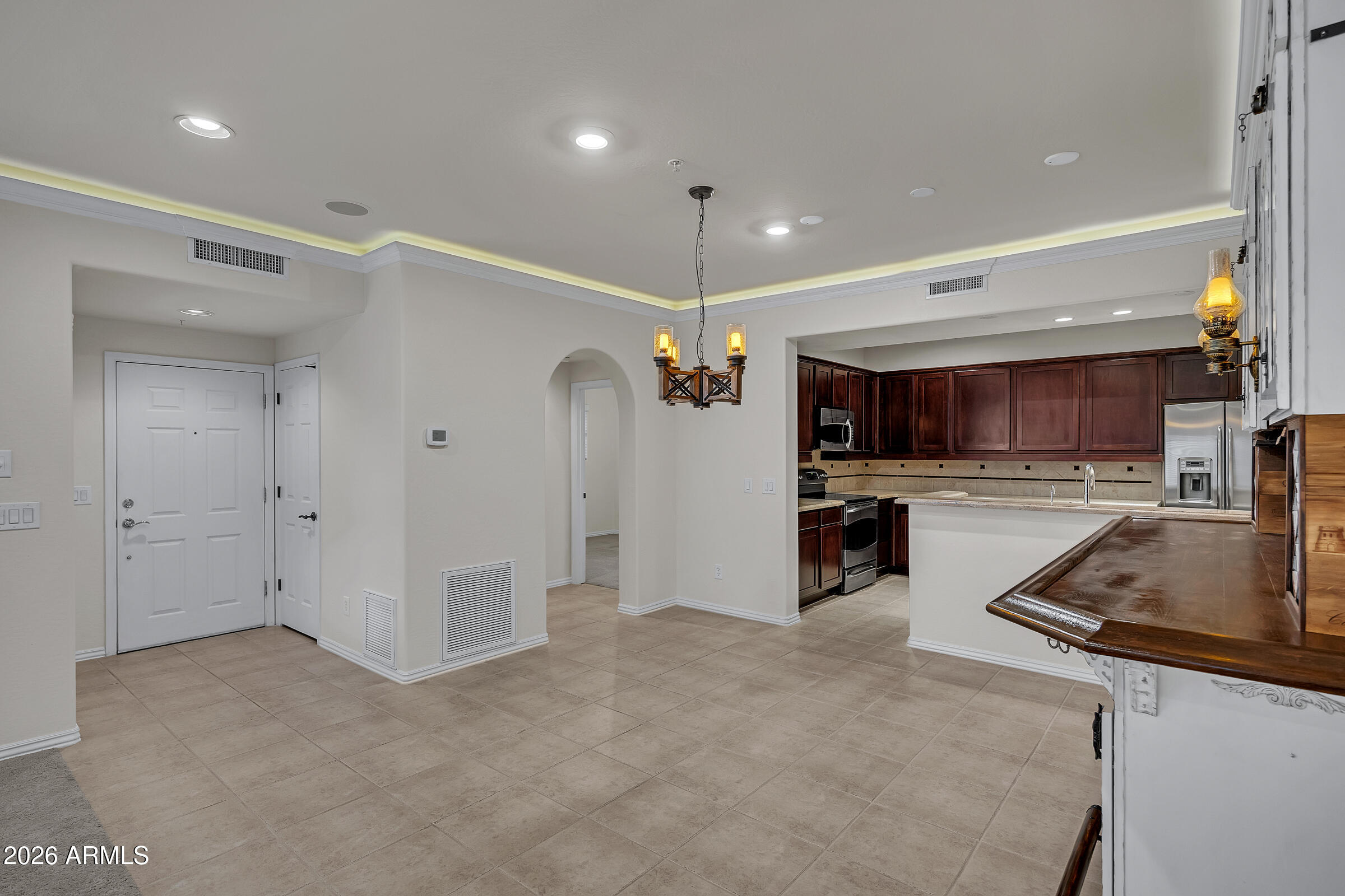 3935 East Rough Rider Road, Unit 1250 Phoenix, AZ 85050 - Photo 7 of 29 a kitchen with stainless steel appliances granite countertop a refrigerator a sink and a stove