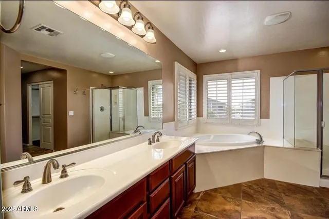a bathroom with a sink double vanity and a large mirror
