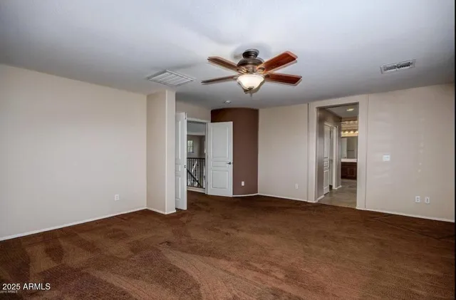 a view of a livingroom with a ceiling fan and window