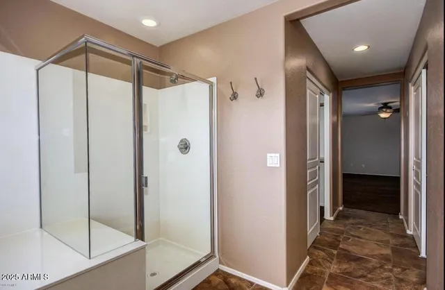 a bathroom with a glass shower door and a glass door