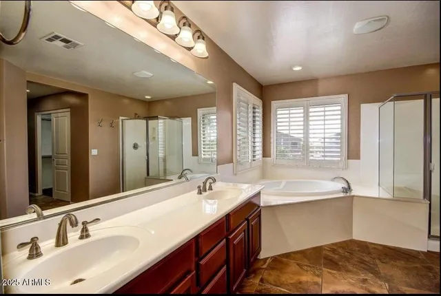 a bathroom with a sink double vanity and a large mirror
