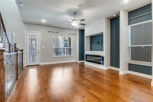 wooden floor in an empty room with a fireplace