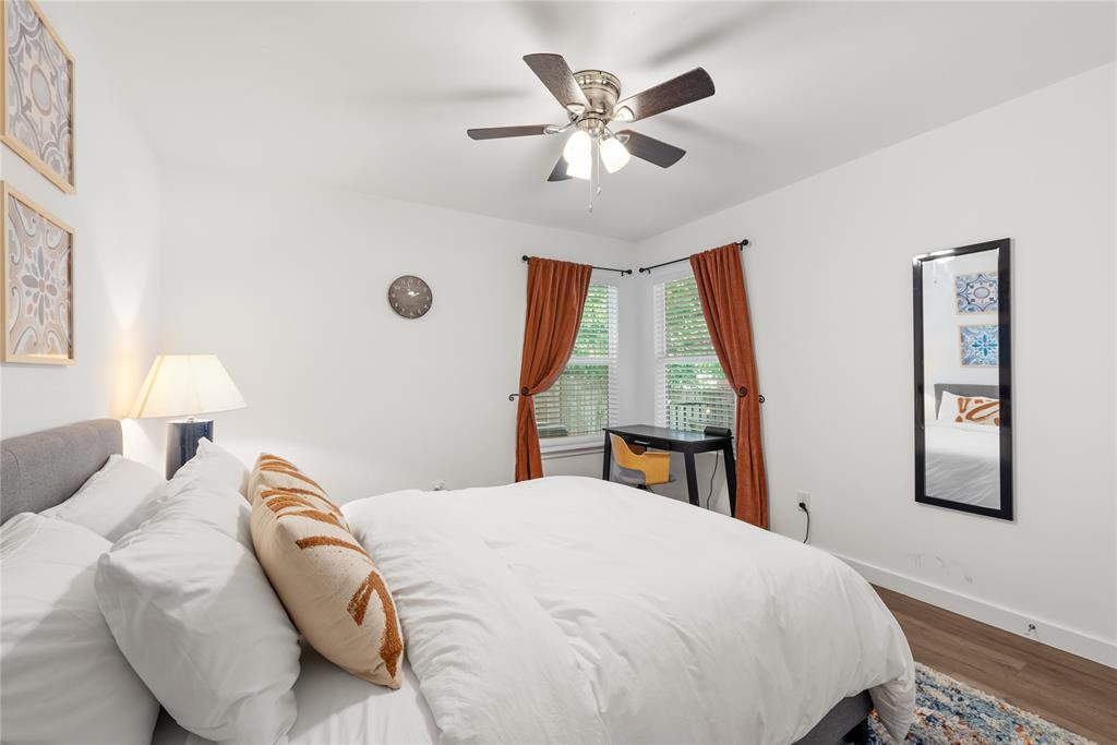 6409 Burns Street, Unit 107 Austin, TX 78752 - Photo 12 of 20 a bedroom with a large bed and a chandelier