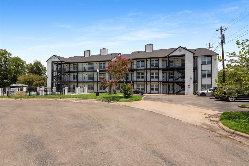 6409 Burns Street, Unit 107 Austin, TX 78752 - Photo 20 of 20 a view of a large building next to a road