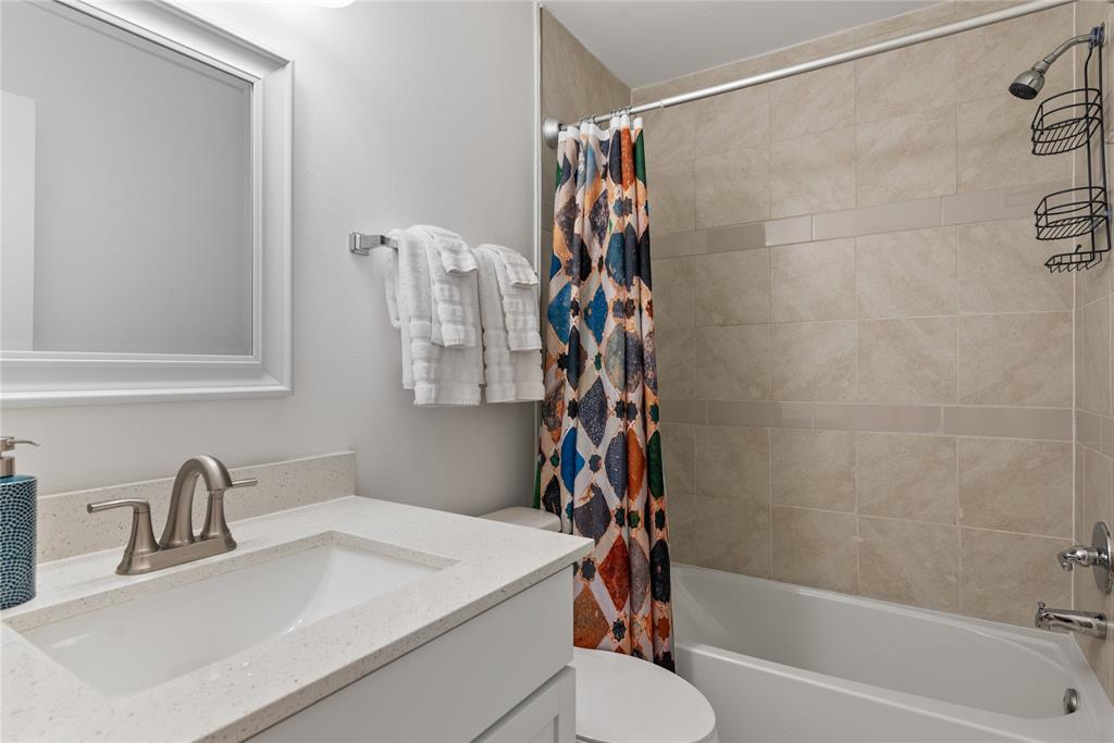 6409 Burns Street, Unit 107 Austin, TX 78752 - Photo 10 of 20 a bathroom with a sink toilet and shower