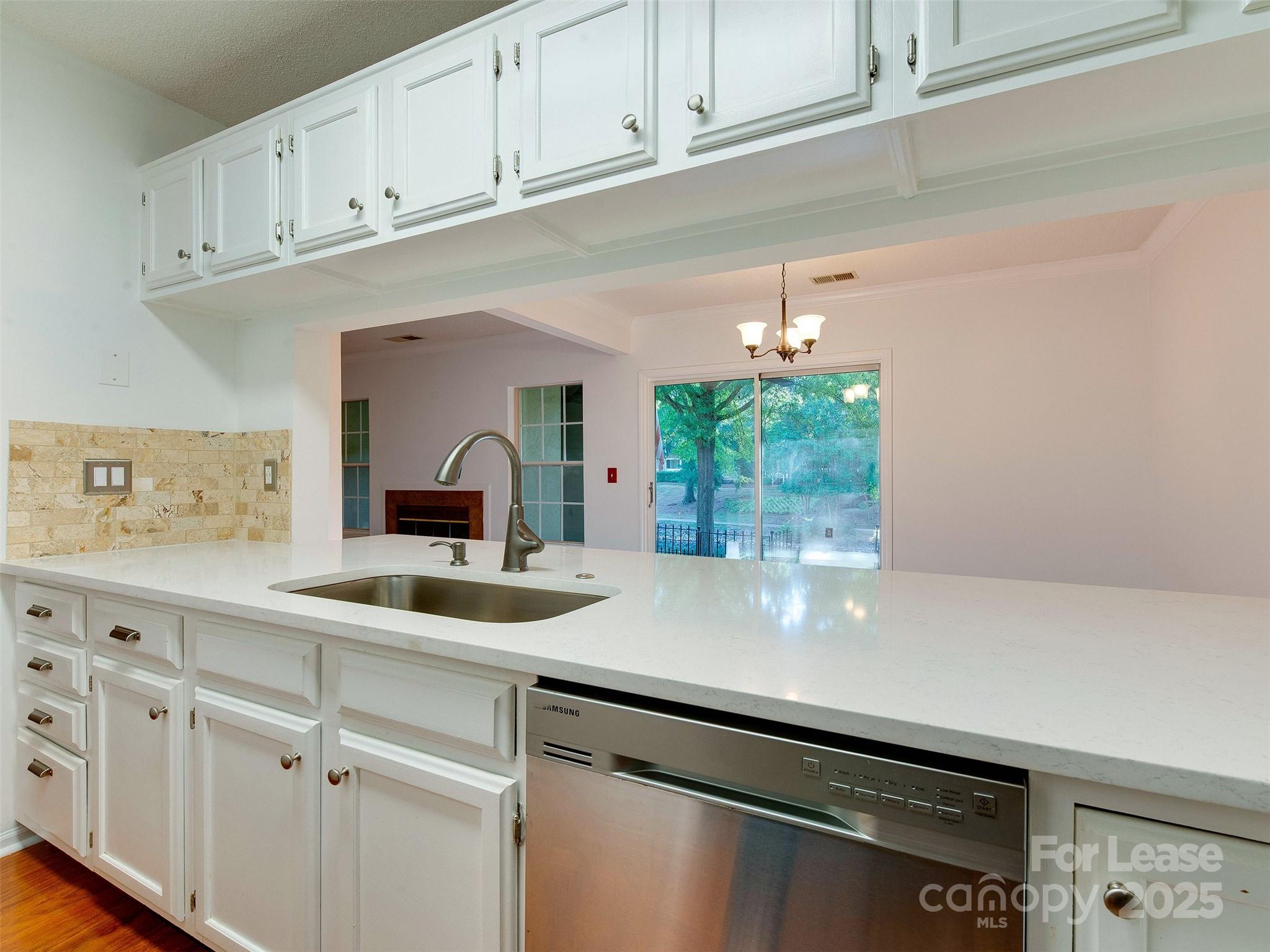 19827 Henderson Road, Unit B Cornelius, NC 28031 - Photo 17 of 48 a kitchen with a sink and cabinets