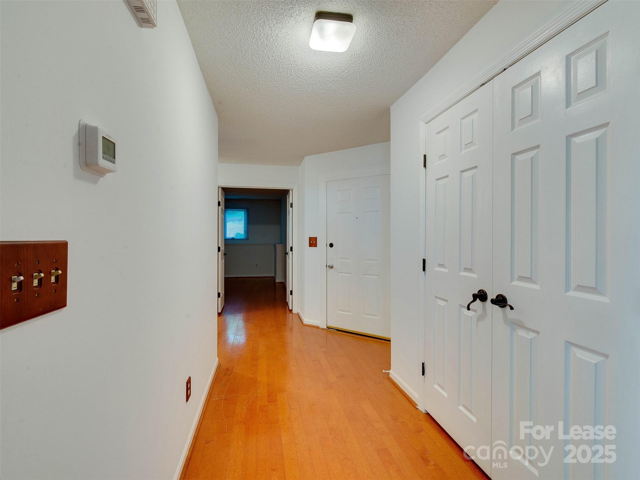 19827 Henderson Road, Unit B Cornelius, NC 28031 - Photo 2 of 48 a view of a hallway with wooden floor and staircase