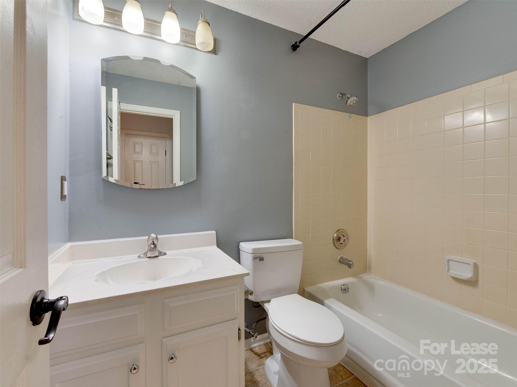 19827 Henderson Road, Unit B Cornelius, NC 28031 - Photo 25 of 48 a bathroom with a sink toilet and shower