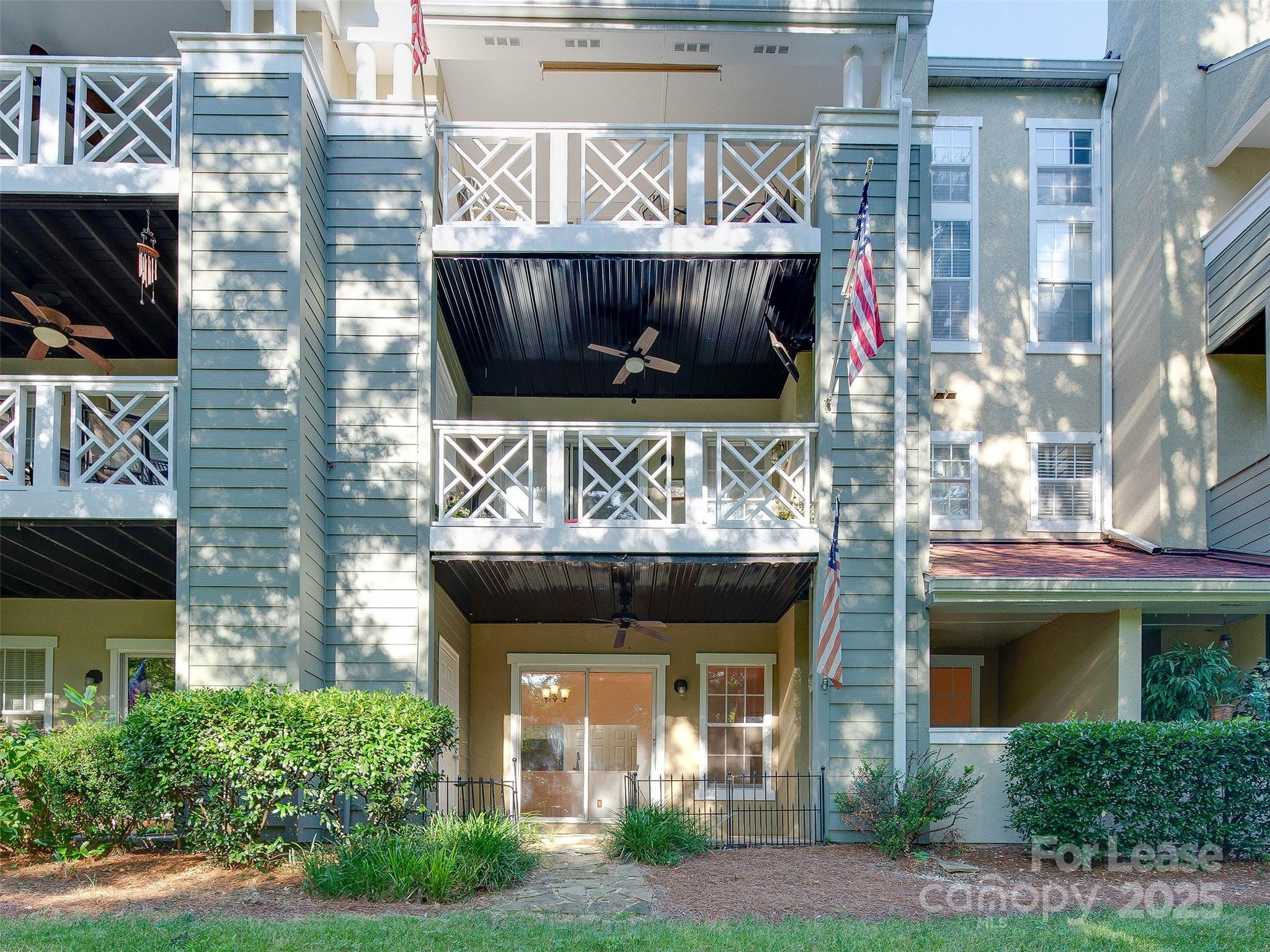 19827 Henderson Road, Unit B Cornelius, NC 28031 - Photo 30 of 48 a front view of a house with a garden and garage