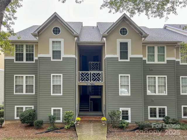 a front view of a house with yard and parking space