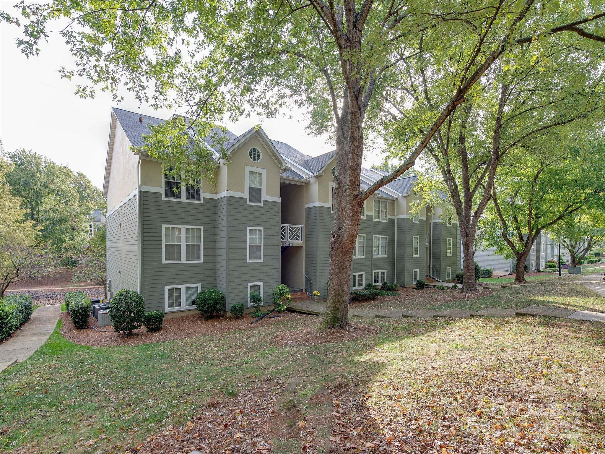 19827 Henderson Road, Unit B Cornelius, NC 28031 - Photo 38 of 48 a view of a house with a yard