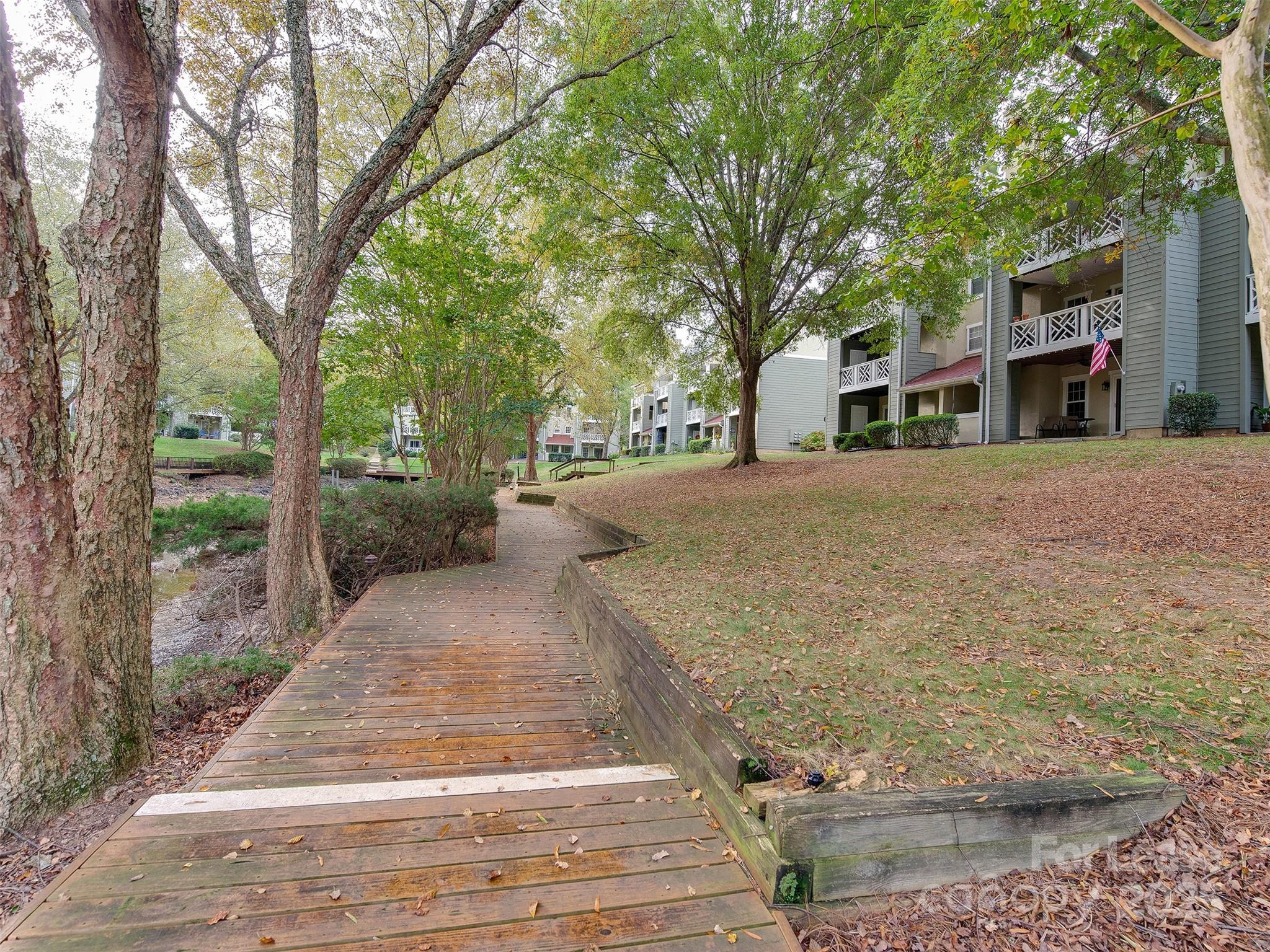 19827 Henderson Road, Unit B Cornelius, NC 28031 - Photo 39 of 48 a front view of a house with a yard