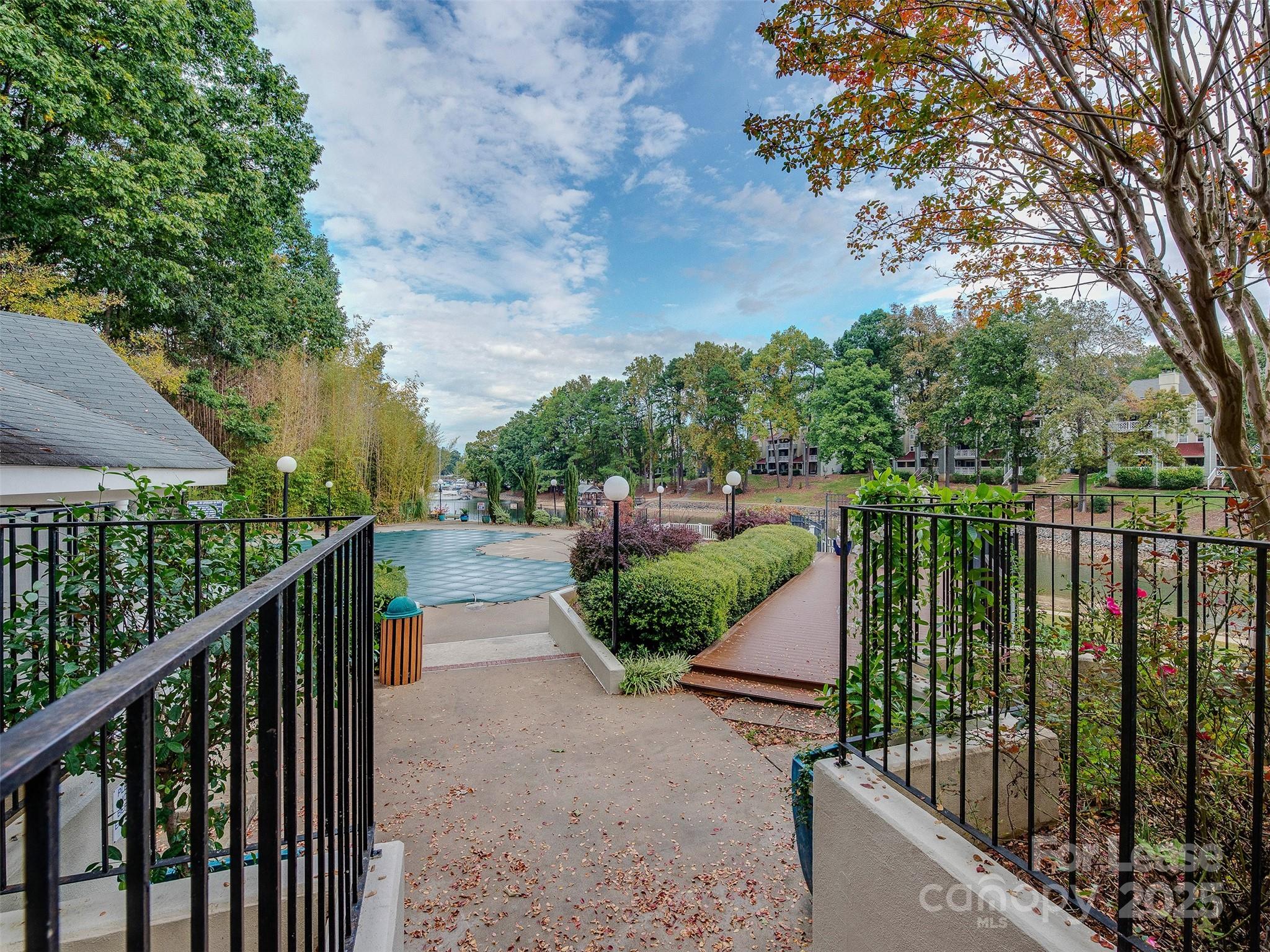 19827 Henderson Road, Unit B Cornelius, NC 28031 - Photo 44 of 48 a balcony with trees in front of it