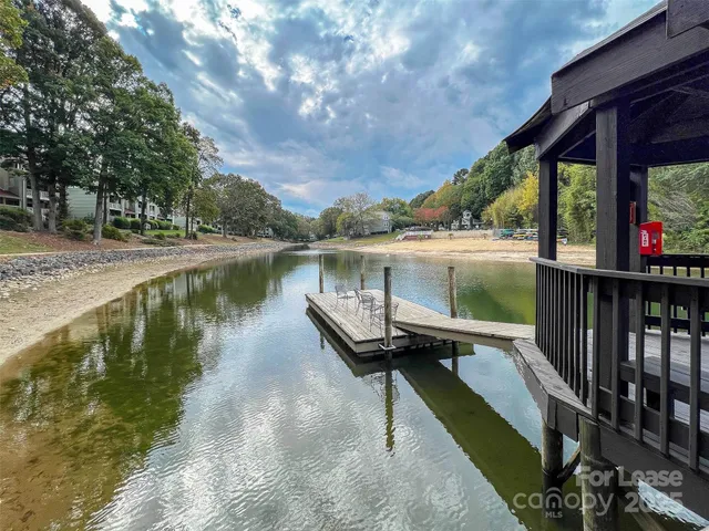 a view of a lake with a yard from a balcony