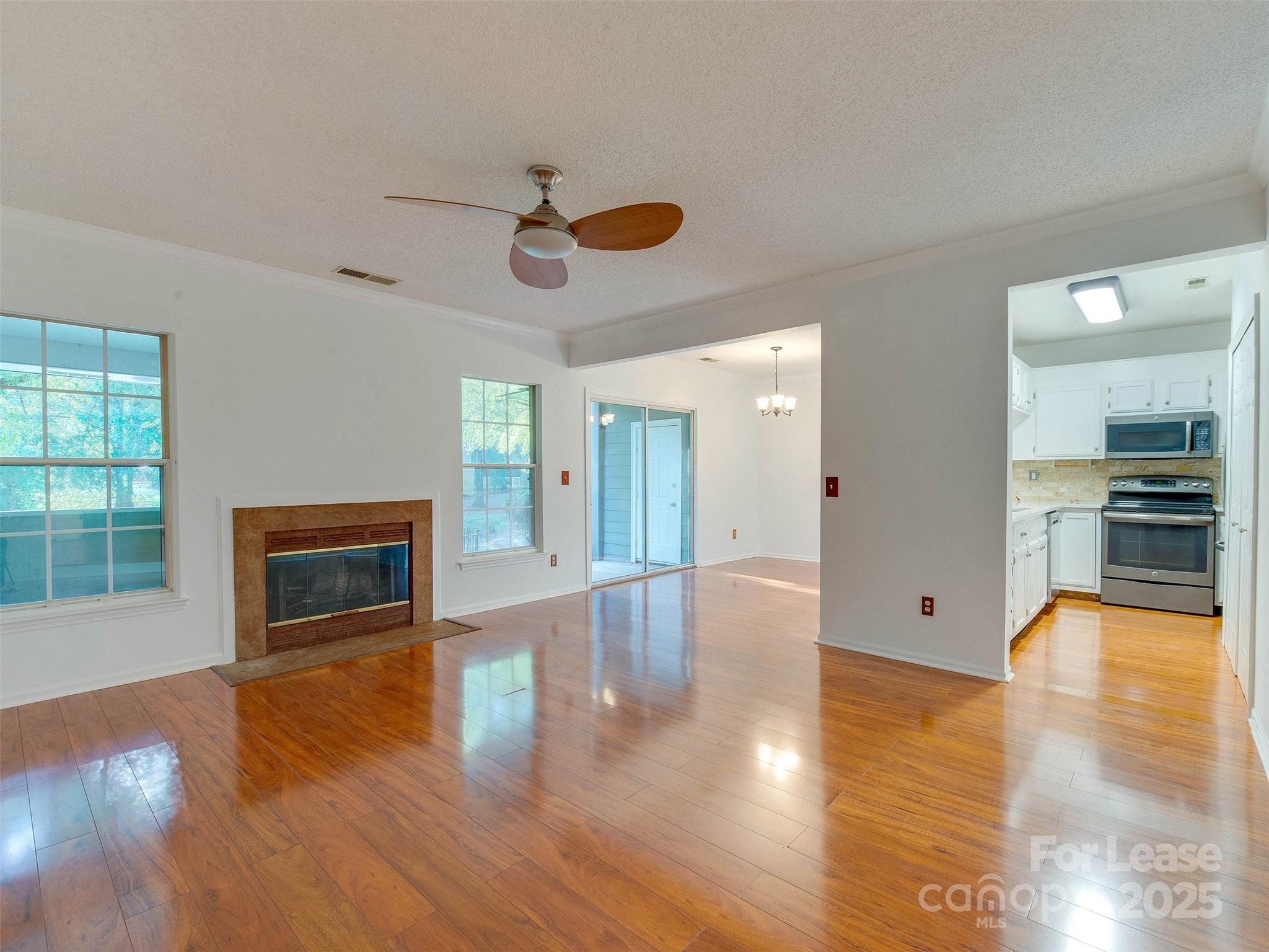19827 Henderson Road, Unit B Cornelius, NC 28031 - Photo 6 of 48 a view of a livingroom with furniture a ceiling fan and window