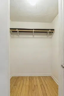 a view of a room with wooden floor and small racks