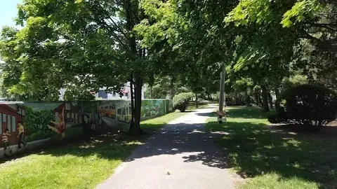 a picture of a bench in front of a wall