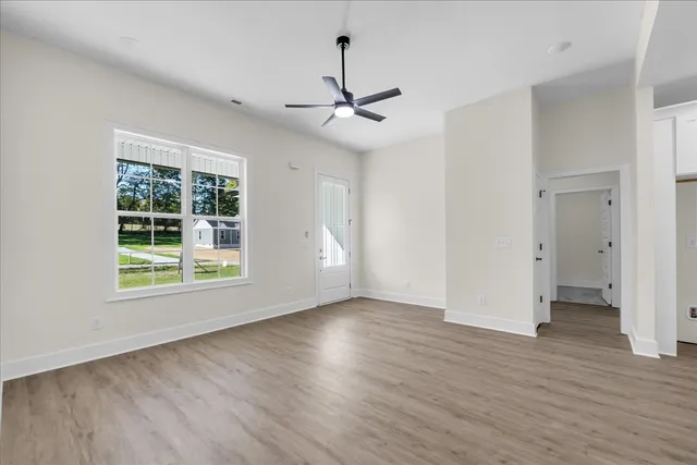 wooden floor in an empty room with a window