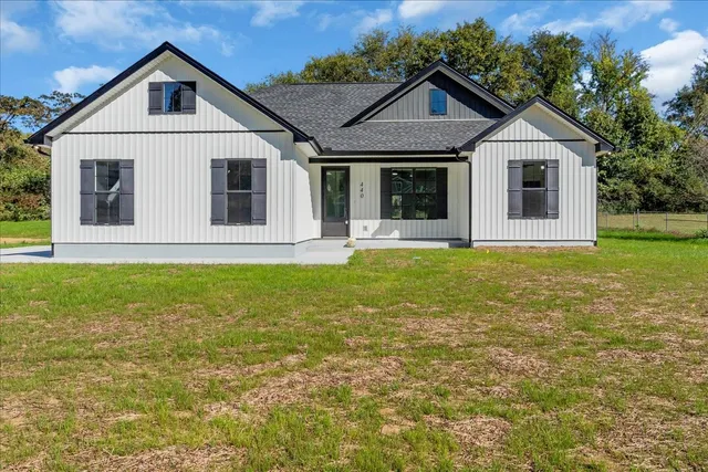 a front view of a house with garden