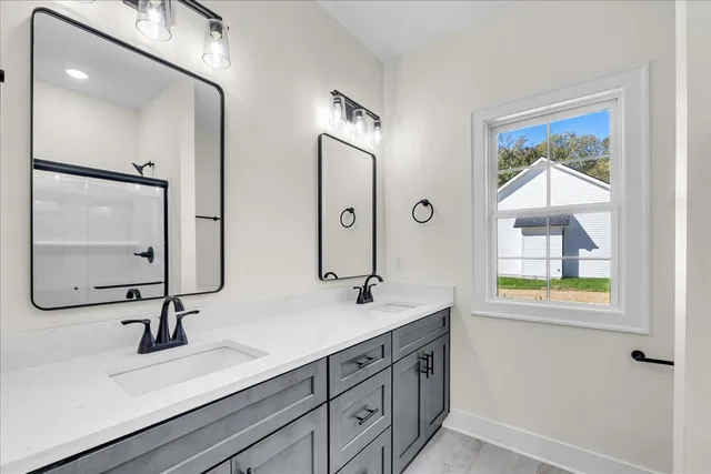 a bathroom with 2 sink and a mirror