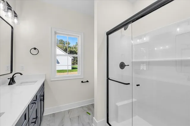a bathroom with a shower and a sink