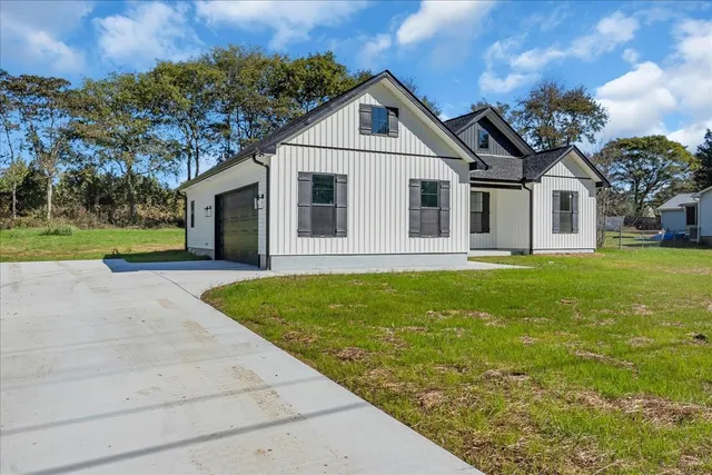 a front view of house with yard and green space