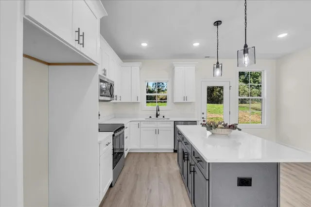 a kitchen with a sink stove and cabinets