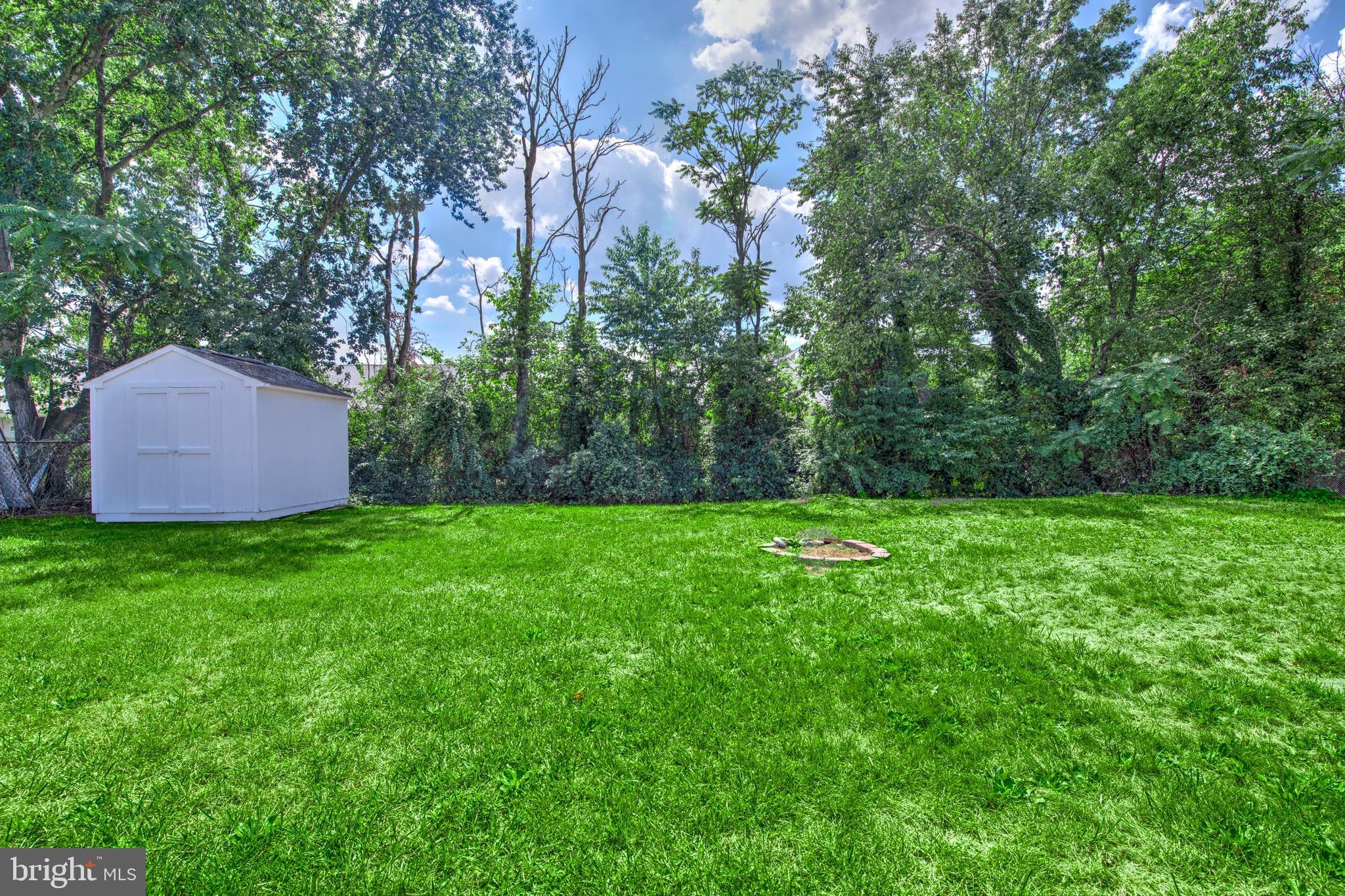 613 Howell Drive Westampton, NJ 08060 - Photo 15 of 18 a backyard of a house with lots of plants and trees
