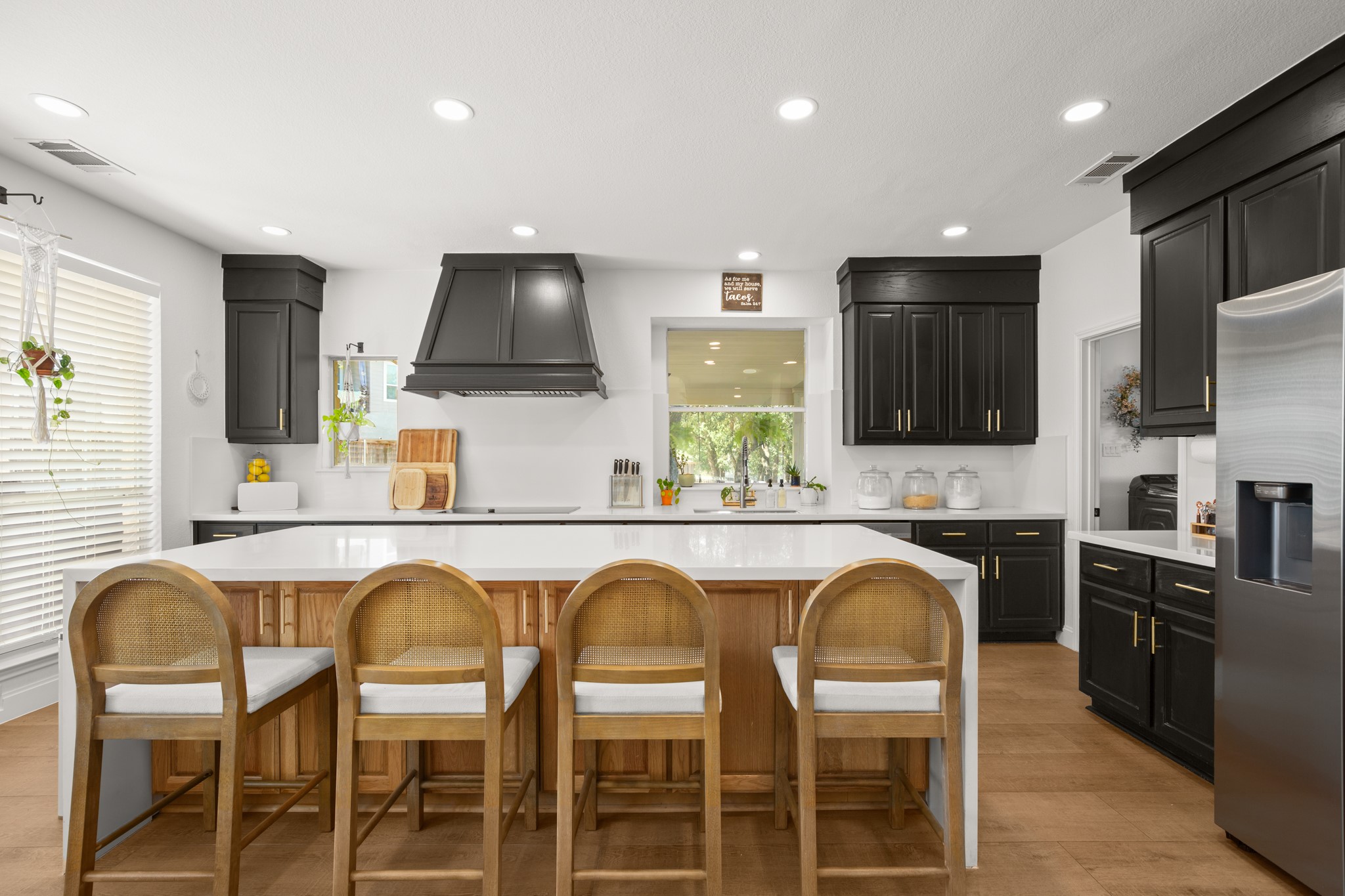314 Ridge View Drive Georgetown, TX 78628 - Photo 6 of 40 A statement range hood gives the cooking area its own moment while the surrounding dark cabinetry creates a rich, modern backdrop. This kitchen has enough personality to be memorable without sacrificing an inch of practicality.