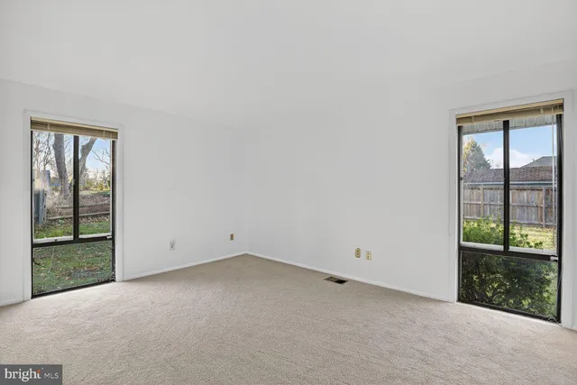 a bathroom with a granite countertop sink a toilet and a mirror