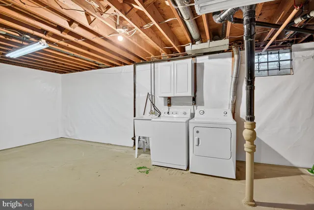 a white house that has a tree in front of it