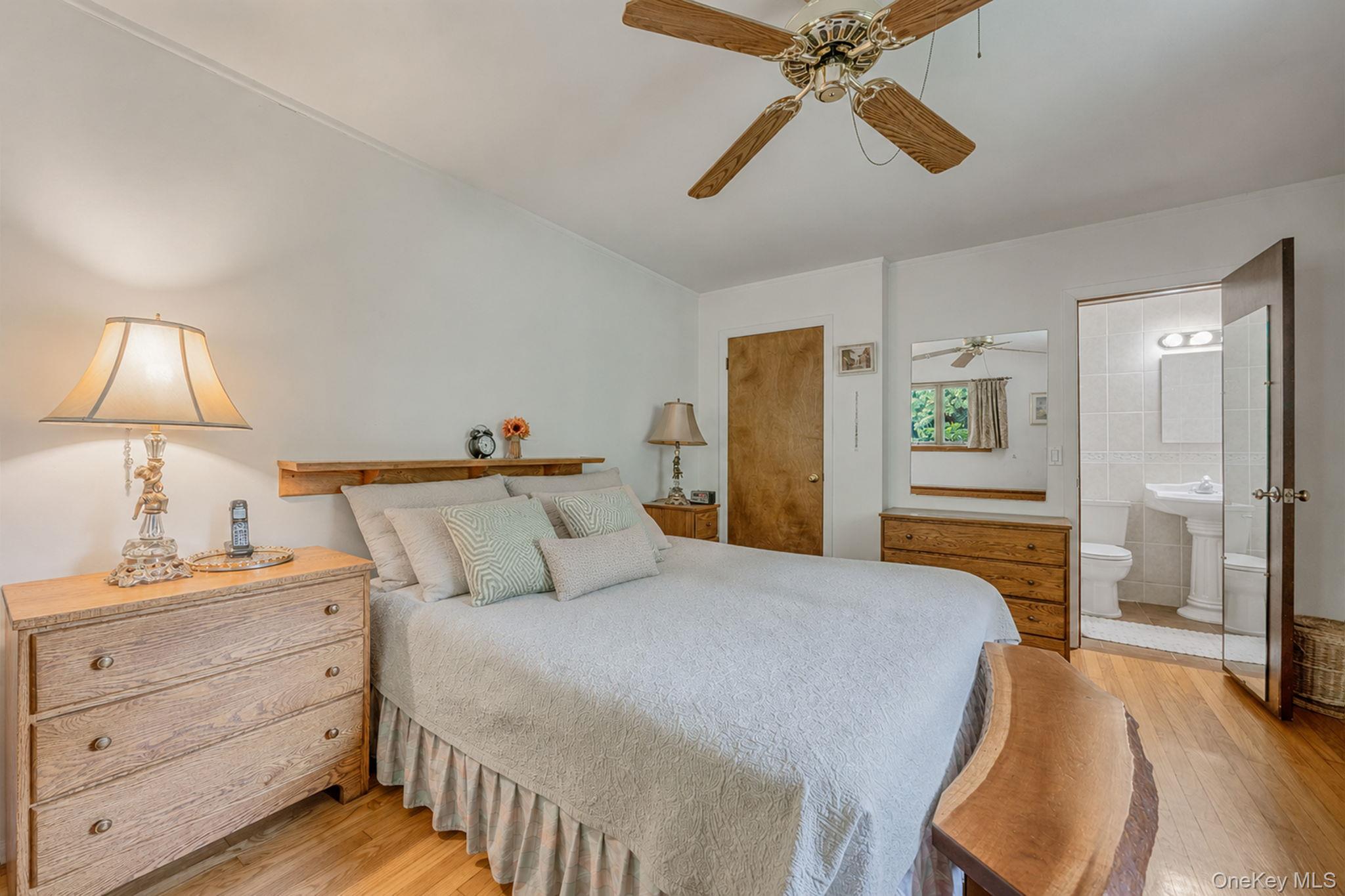 280 Deforest Road North Dix Hills, NY 11746 - Photo 26 of 37 a bedroom with a bed and a chandelier