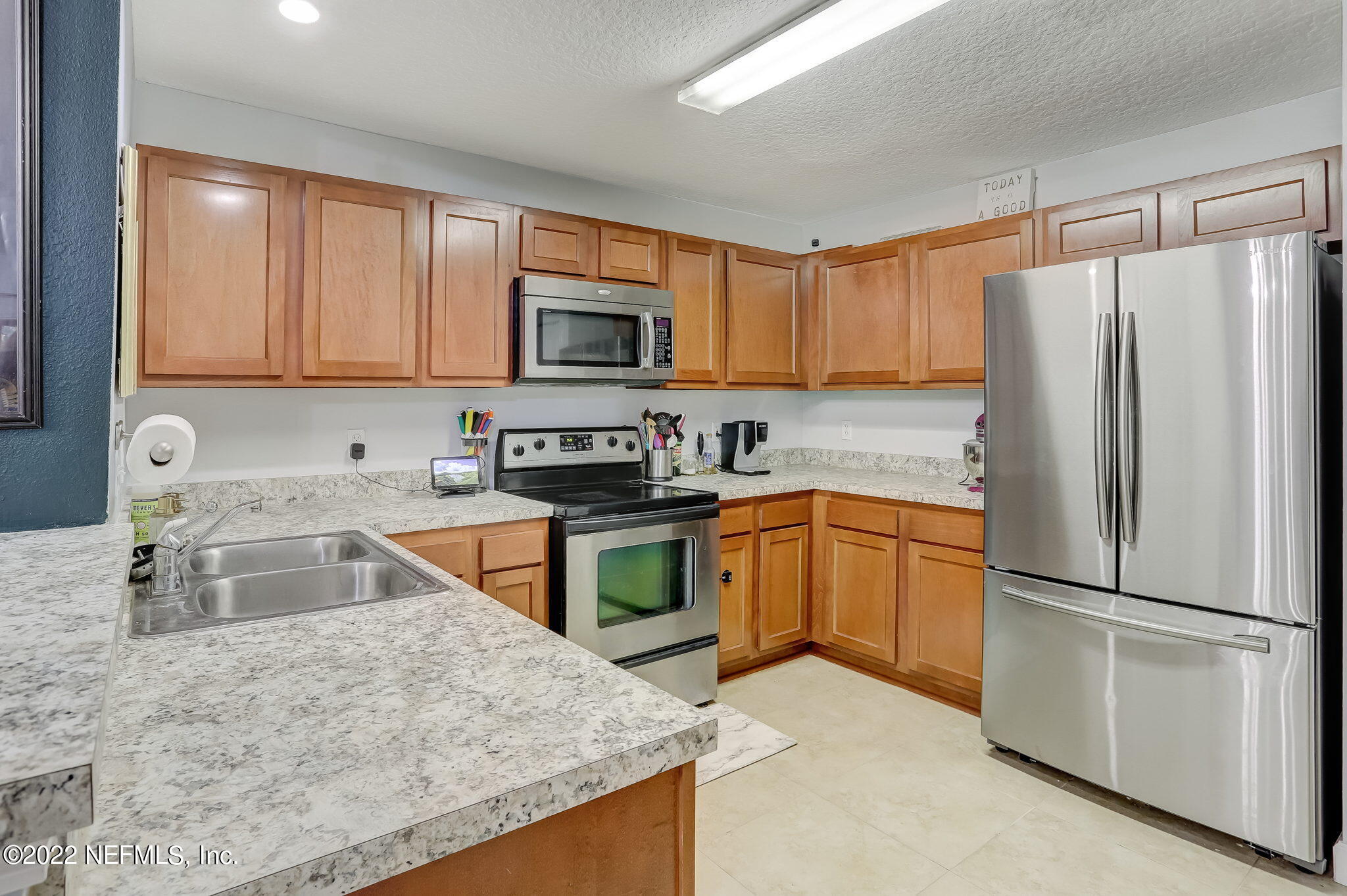 3690 Kirkpatrick Circle, Unit 710 Jacksonville, FL 32210 - Photo 14 of 34 a kitchen with granite countertop a refrigerator stove top oven a sink and dishwasher