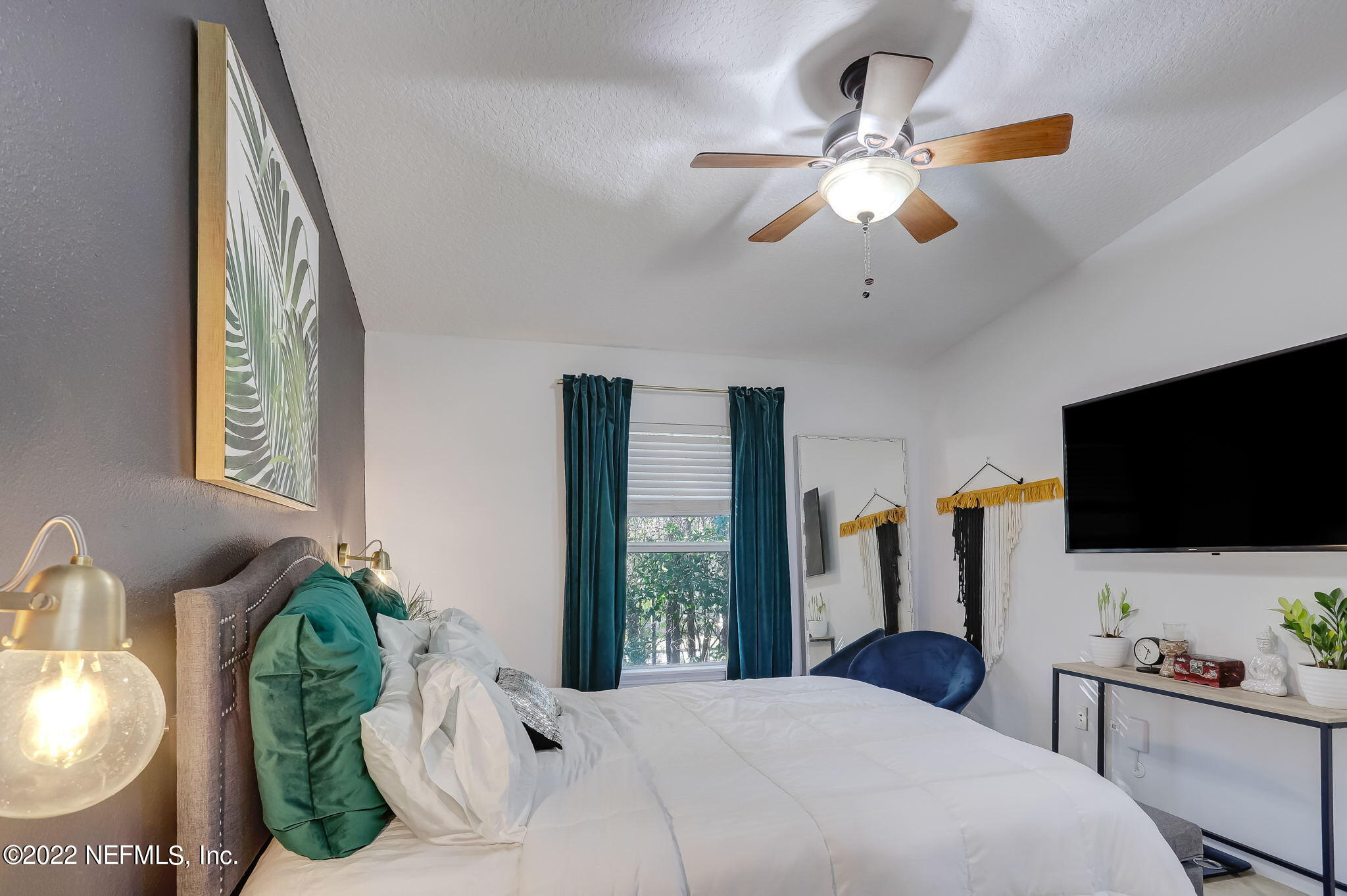 3690 Kirkpatrick Circle, Unit 710 Jacksonville, FL 32210 - Photo 18 of 34 a bedroom with a bed and a flat screen tv