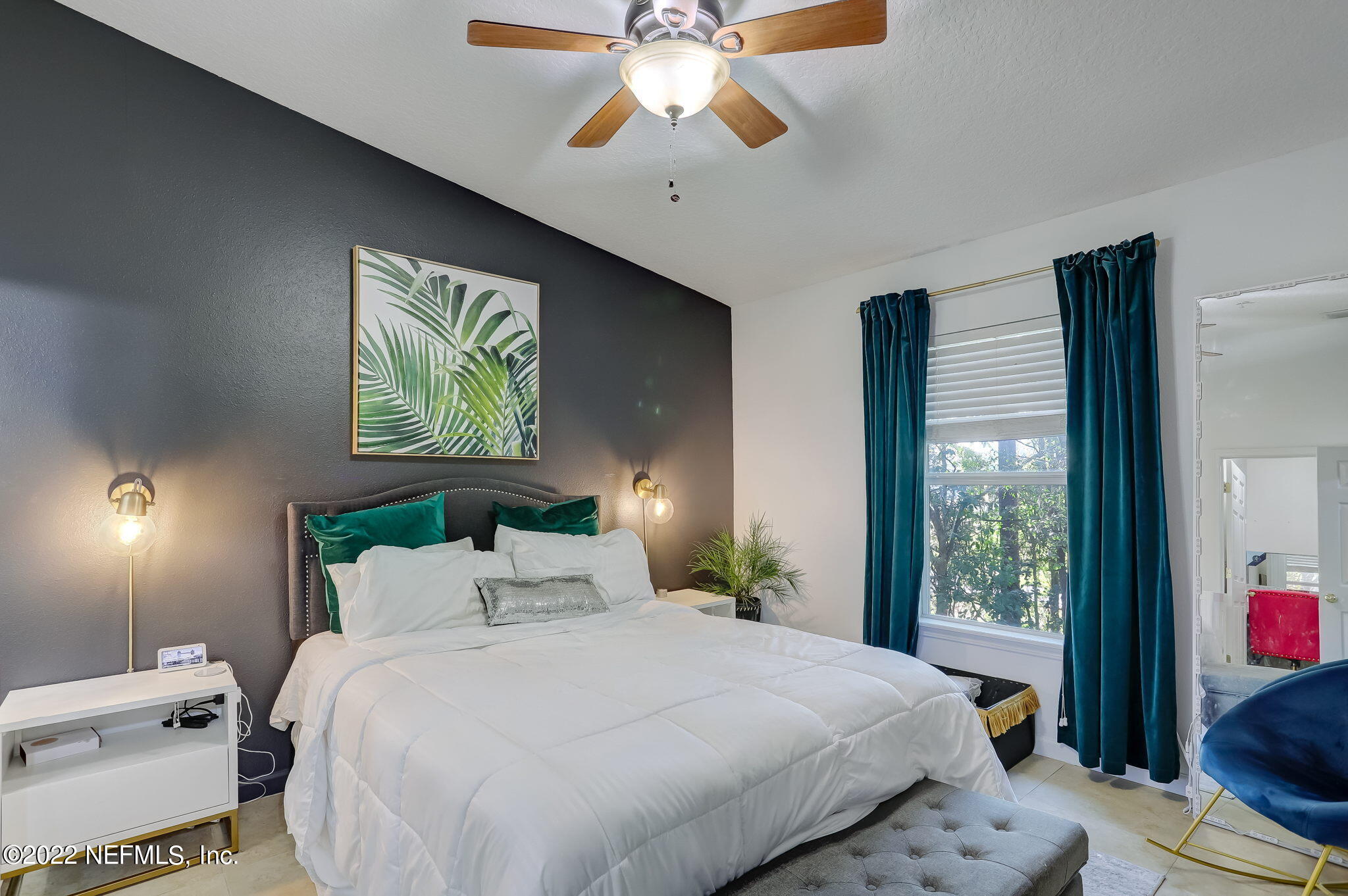 3690 Kirkpatrick Circle, Unit 710 Jacksonville, FL 32210 - Photo 19 of 34 a bedroom with a bed and a chandelier