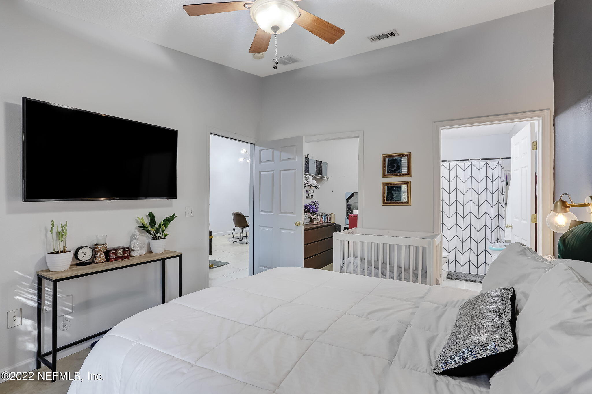 3690 Kirkpatrick Circle, Unit 710 Jacksonville, FL 32210 - Photo 20 of 34 a bedroom with a bed and a flat screen tv