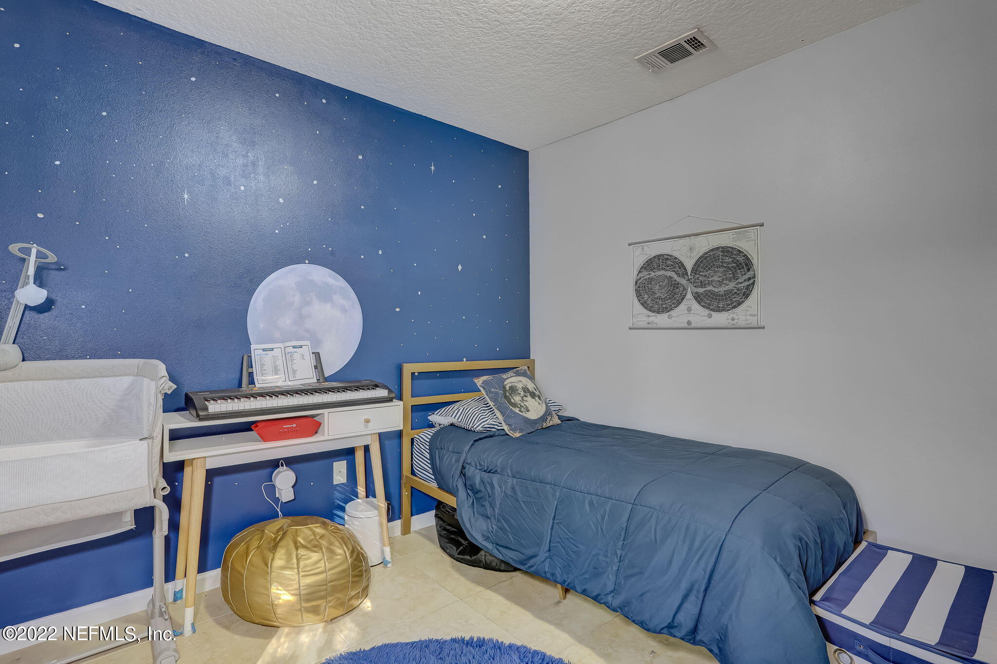 3690 Kirkpatrick Circle, Unit 710 Jacksonville, FL 32210 - Photo 26 of 34 a bedroom with bed and a chandelier