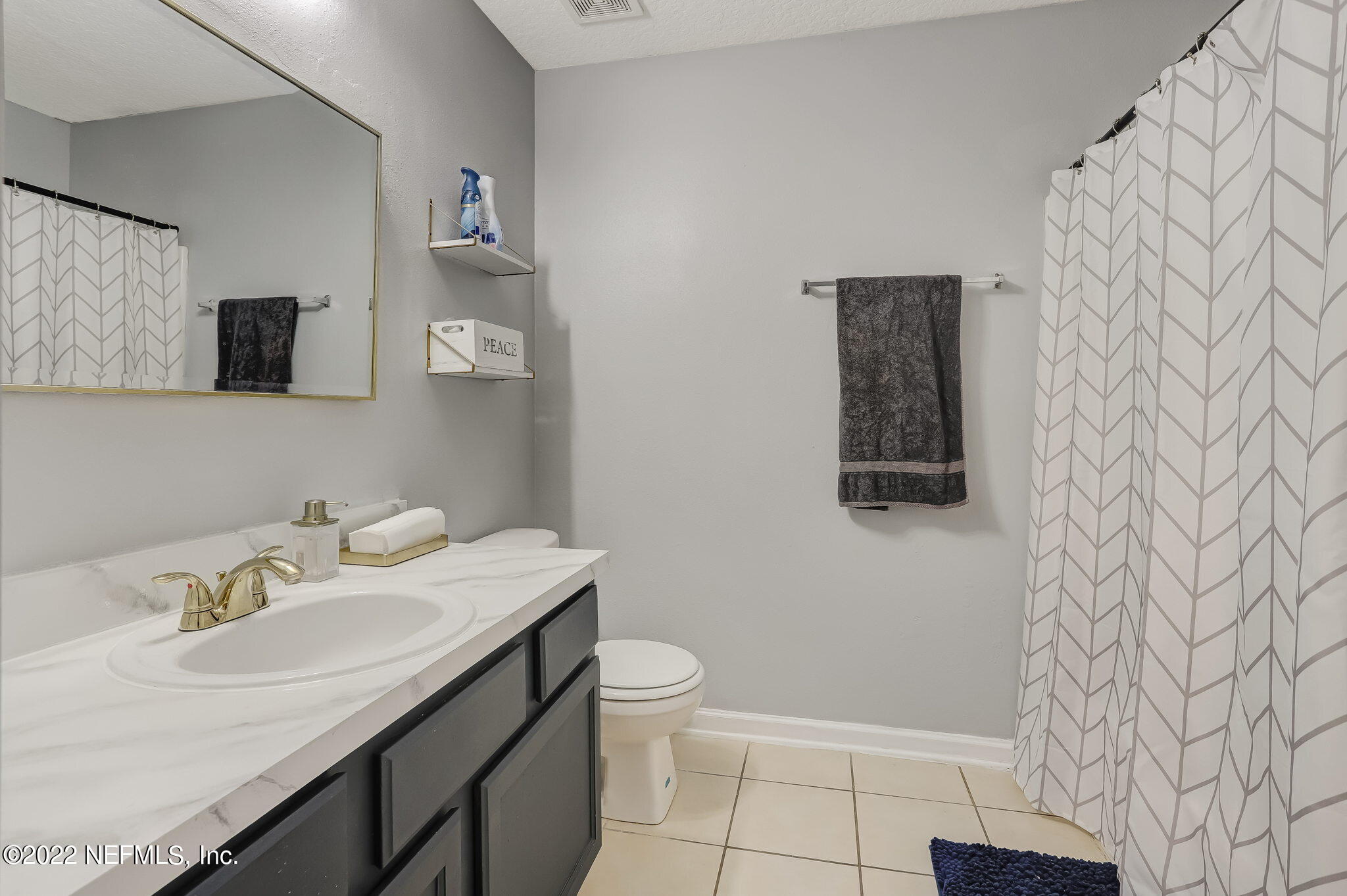 3690 Kirkpatrick Circle, Unit 710 Jacksonville, FL 32210 - Photo 31 of 34 a bathroom with a sink and a mirror