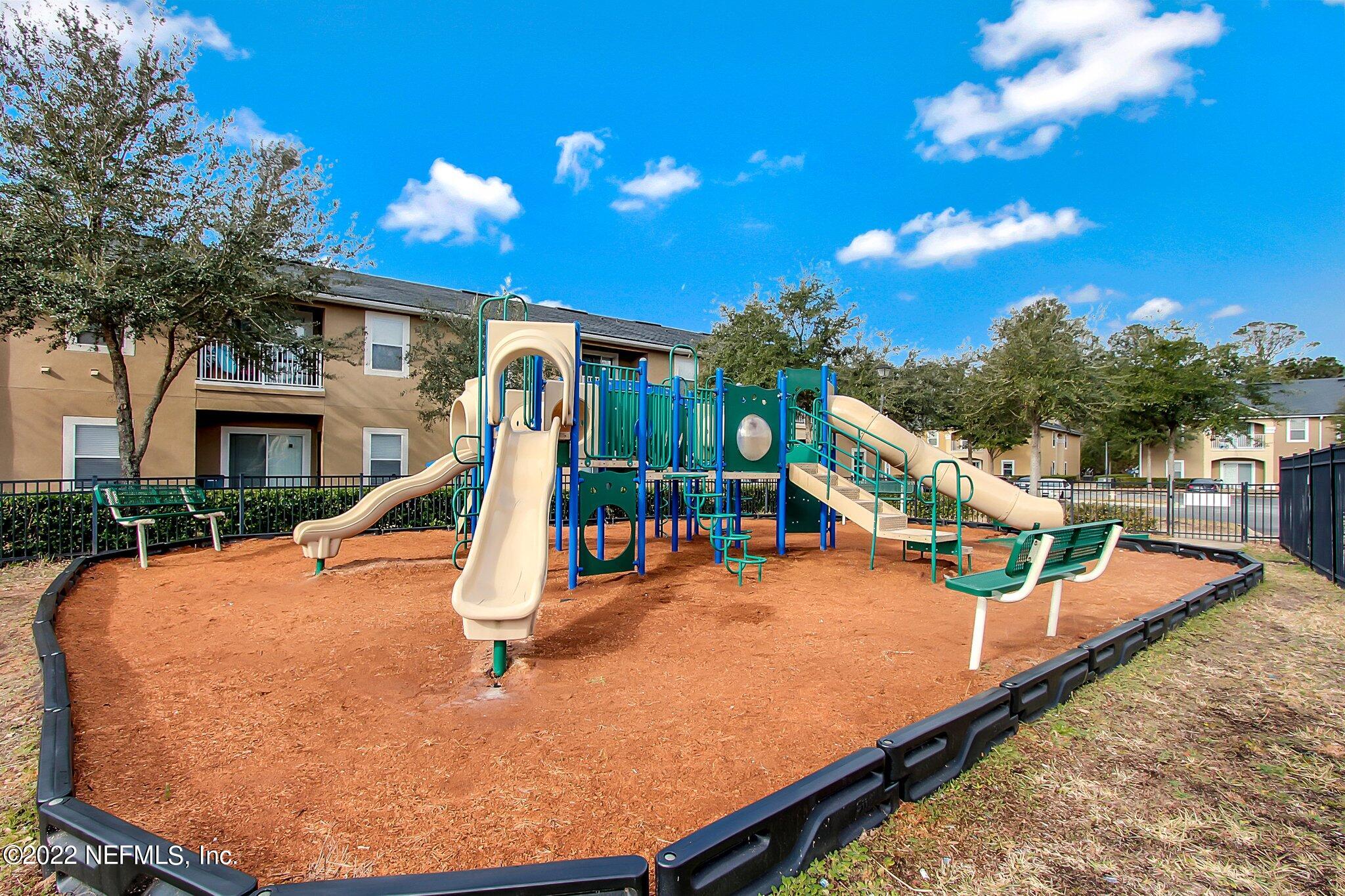 3690 Kirkpatrick Circle, Unit 710 Jacksonville, FL 32210 - Photo 33 of 34 a view of a swimming pool with a patio and a yard