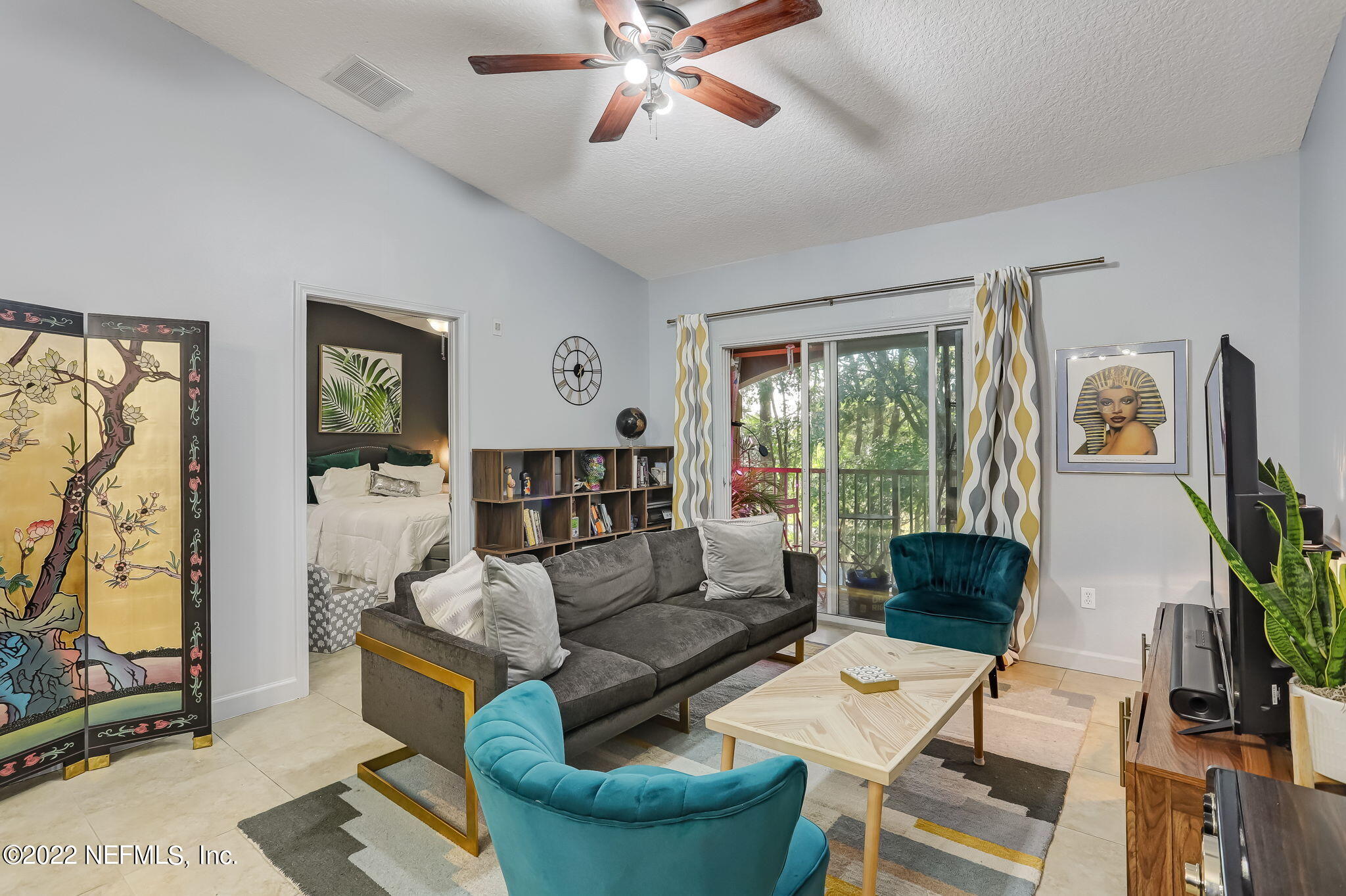 3690 Kirkpatrick Circle, Unit 710 Jacksonville, FL 32210 - Photo 9 of 34 a living room with furniture and floor to ceiling windows