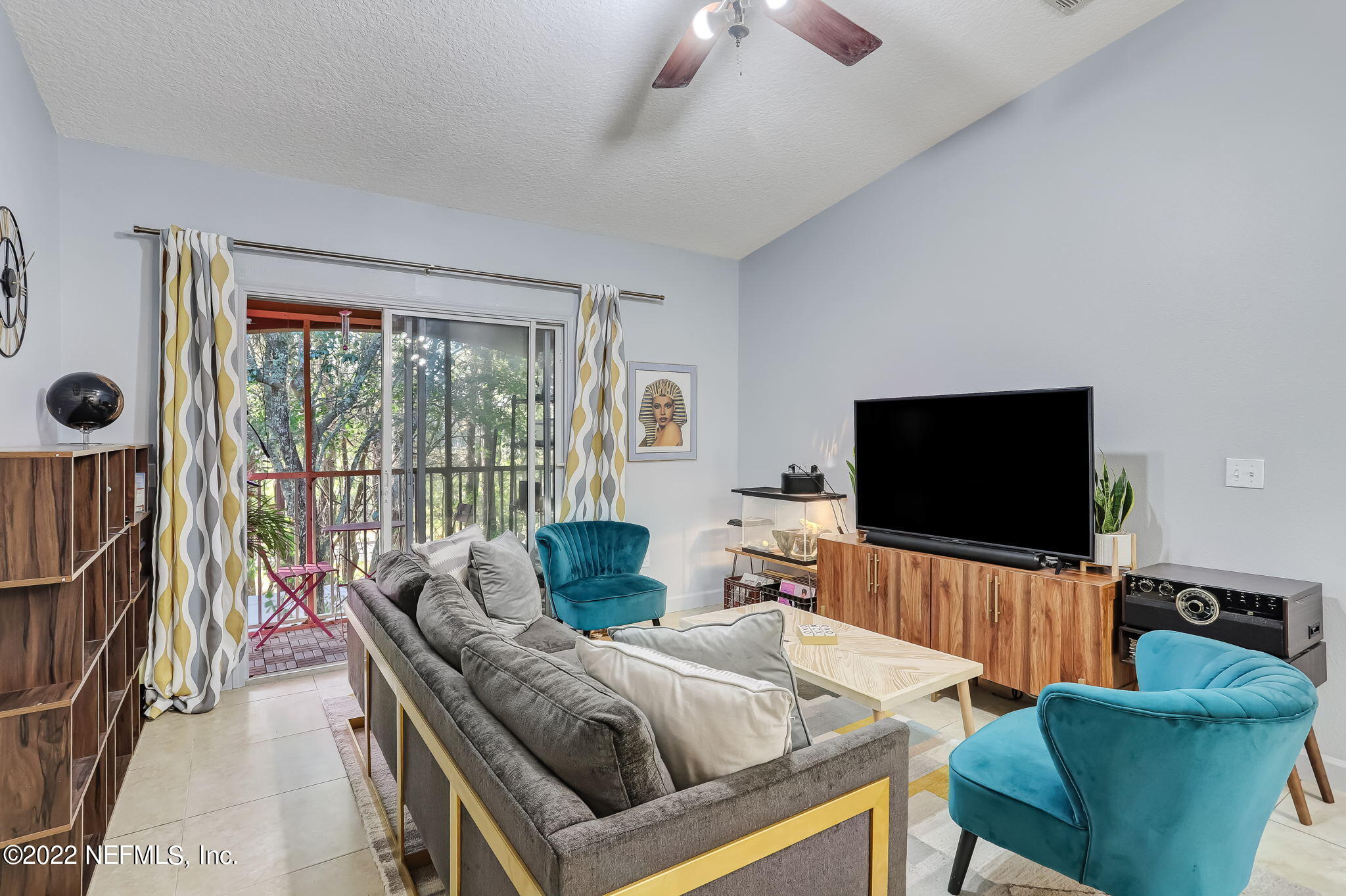 3690 Kirkpatrick Circle, Unit 710 Jacksonville, FL 32210 - Photo 10 of 34 a living room with furniture and a flat screen tv