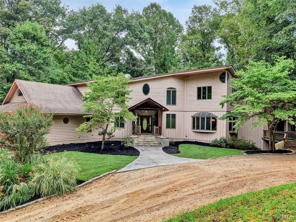 7461 Pine Ridge Road Mechanicsville, VA 23116 - Photo 1 of 42 a front view of a house with garden