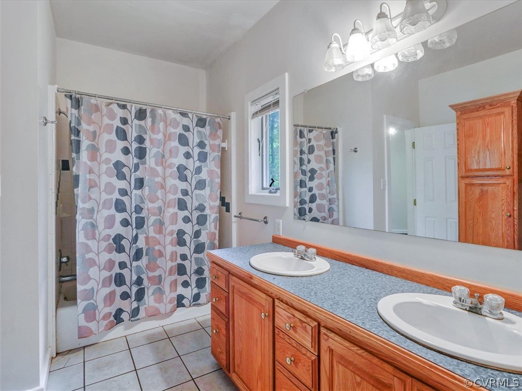 7461 Pine Ridge Road Mechanicsville, VA 23116 - Photo 37 of 42 a bathroom with a granite countertop sink a mirror a vanity and a shower