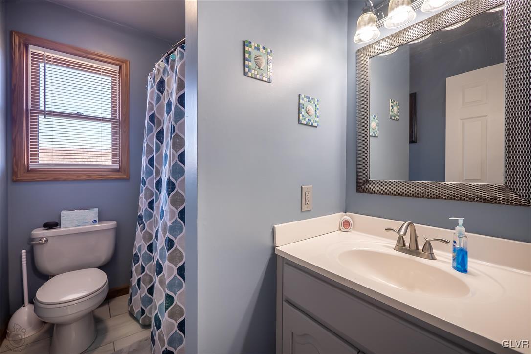 110 Deer Run Road Stroudsburg, PA 18360 - Photo 25 of 50 a bathroom with a granite countertop toilet sink and a mirror