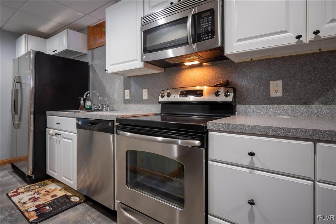 110 Deer Run Road Stroudsburg, PA 18360 - Photo 27 of 50 a kitchen with stainless steel appliances granite countertop a stove microwave and sink