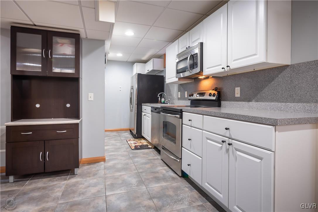 110 Deer Run Road Stroudsburg, PA 18360 - Photo 29 of 50 a kitchen with stainless steel appliances granite countertop a stove a sink and a refrigerator