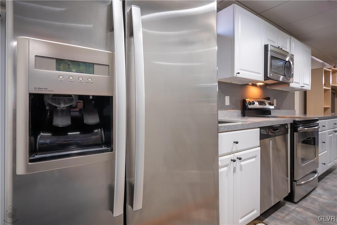 110 Deer Run Road Stroudsburg, PA 18360 - Photo 30 of 50 a kitchen with a refrigerator and cabinets