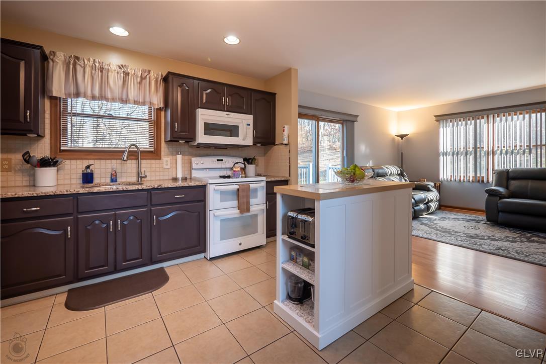 110 Deer Run Road Stroudsburg, PA 18360 - Photo 3 of 50 a kitchen with stainless steel appliances a sink a stove a refrigerator cabinets and a window